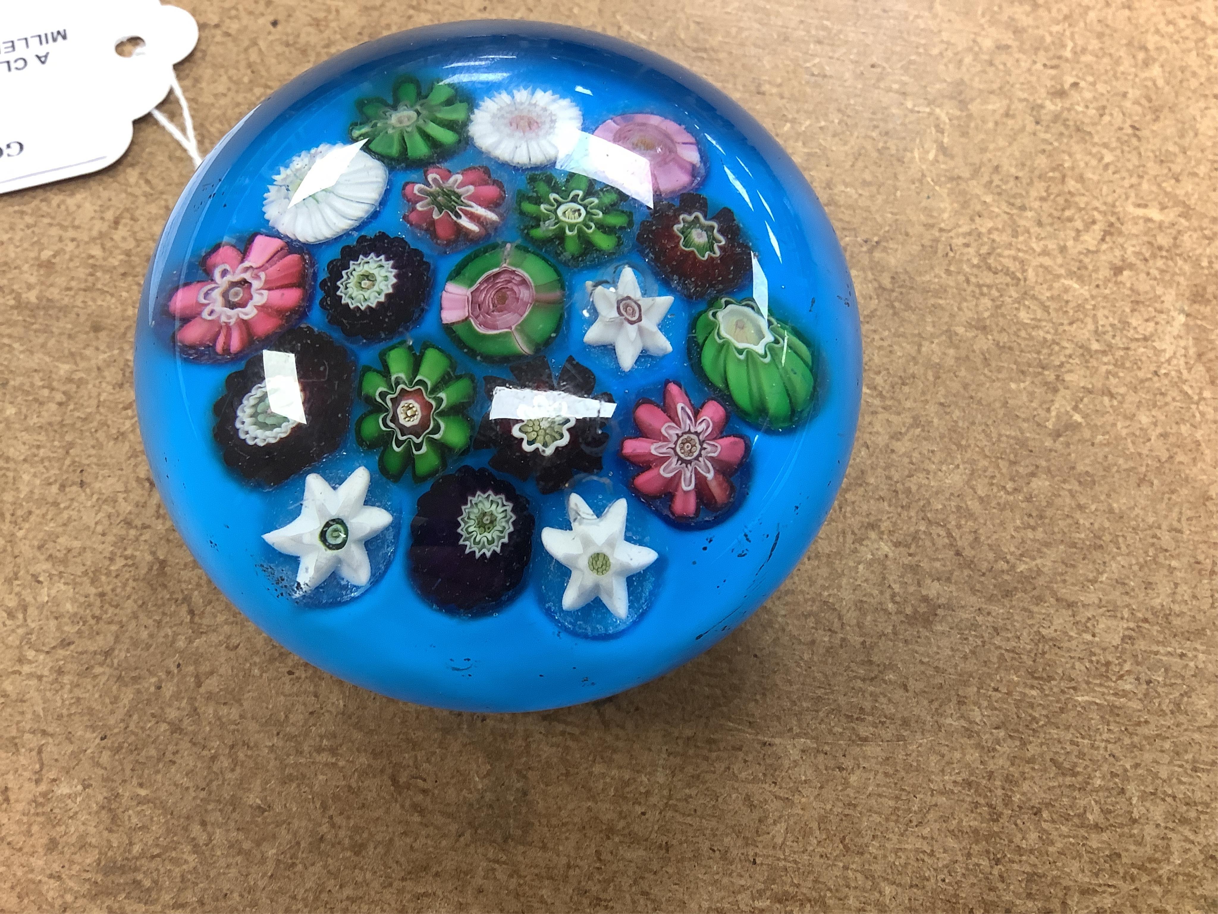 A Clichy scattered millefiori blue ground paperweight, mid 19th century, 7cm. Condition - poor to fair, impact damage